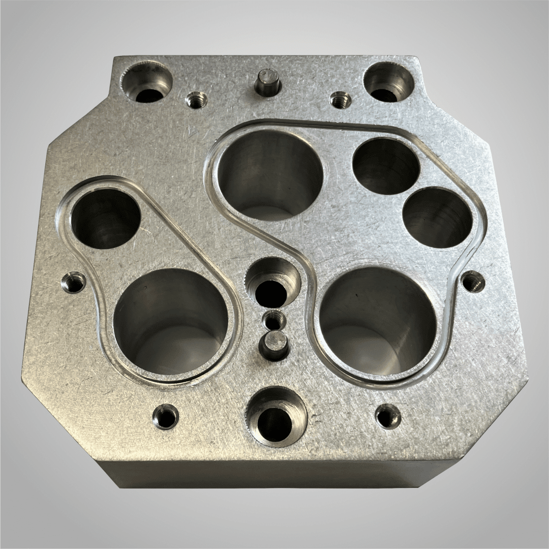 CNC aluminum machined part with bored holes and O-ring grooves